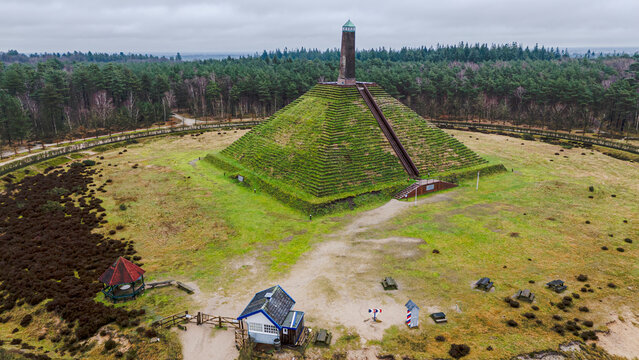 Aerial view of the historic Pyramid Van Austerlitz surrounded by lush green forest and scenic pathways, Woudenberg, The Netherlands.