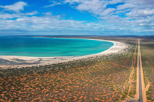 Aerial view of serene Shell Beach with clear waters and expansive coastline, Shell Beach Conservation Park, Shark Bay, Western Australia.
