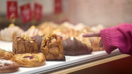 A beautiful display of pastries is enticing customers at a lovely bakery showcase, perfect for food lovers