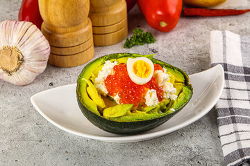Avocado with red caviar and quil egg