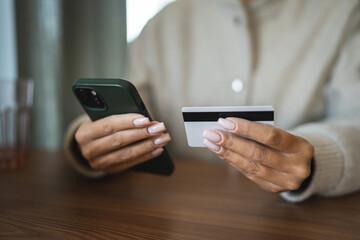 Adult woman use smart phone for online shopping transaction safely