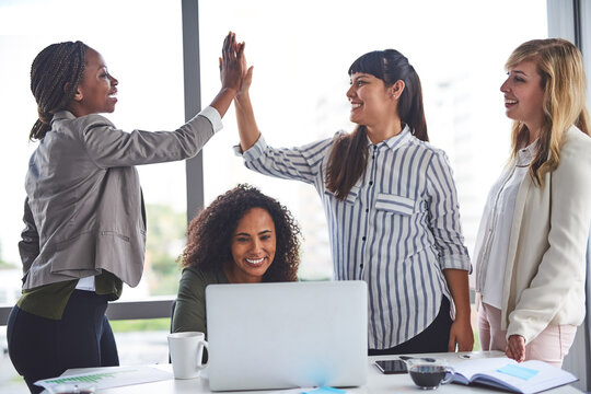 Success, high five and group of women, laptop and celebration with smile and support in office. Meeting, legal and holding hands for win, ombudsman and happy with report, victory and corporate people