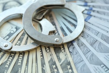 Handcuffs and a lot of dollars scattered on the table