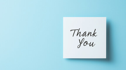 Close-up of a handwritten "Thank You" note on a soft pastel blue background, minimalism, gratitude, simple design, handwritten card