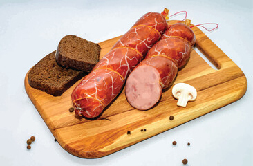 Tasty sausages and vegetables isolated over solid background