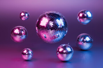Disco balls floating on purple background celebrating new year's eve party
