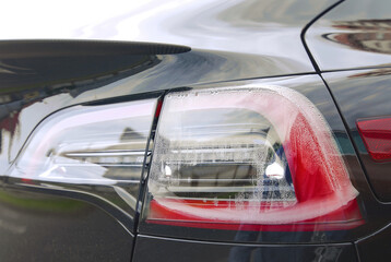 Moisture in the rearlamp. Condensation in taillights, wet rear lamp. Led car lamp with water condensation. Fogged up taillight lense, closeup. Headlight with water drops inside. Selective focus