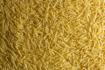 Uncooked Filini Pasta: A Culinary Canvas of Noodles, Creating a Lively and Textured Background for Gourmet Cooking. Dry Pasta. Raw Macaroni - Top View, Flat Lay