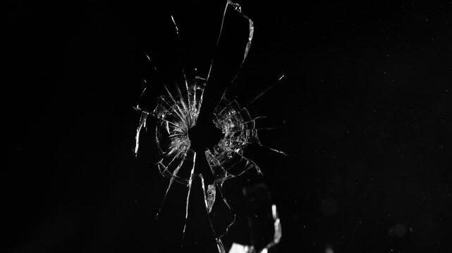 Super Slow Motion of Shattered Glass Isolated on Black Background. Break Glass from the Gunshot. Filmed on High Speed Cinema Camera, 1000 fps.
