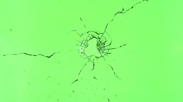 Super Slow Motion of Shattered Glass Isolated on Green Background. Break Glass from the Gunshot. Filmed on High Speed Cinema Camera, 1000 fps.