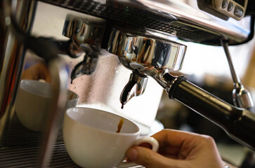 Barista making coffee from a coffee machine