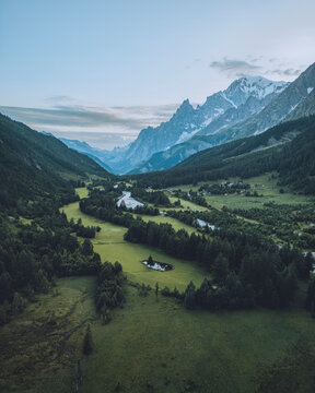 Aerial view of serene Val Ferret valley with majestic Mont Blanc and flowing Dora di Ferret river, Courmayeur, Italy.