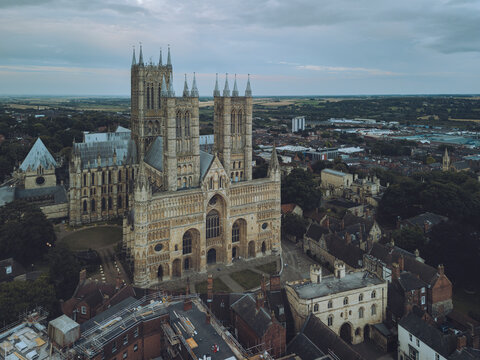 Aerial view of historic Lincoln Cathedral amidst a beautiful cityscape, Lincoln, United Kingdom.