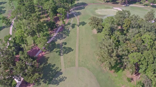 Aerial view of beautiful golf course surrounded by lush green trees and fairways, Thomasville, United States.