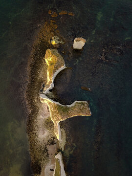Aerial view of beautiful rocky cliffs and serene blue sea, Studland, England.