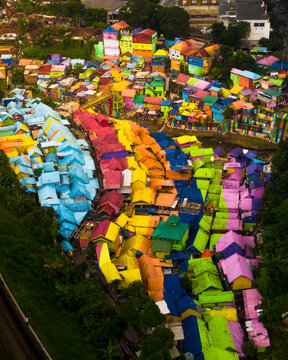 Aerial view of colorful rooftops and houses in a vibrant village, Blimbing, East Java, Indonesia.