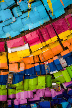 Aerial view of colorful rooftops and houses in a vibrant neighborhood, Blimbing, East Java, Indonesia.
