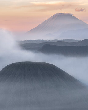 Aerial view of bromo mountain shrouded in fog at dawn, Tosari, East Java, Indonesia.
