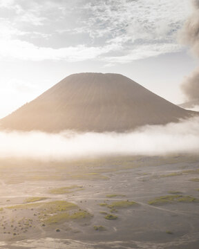 Aerial view of majestic mountain peak surrounded by serene clouds and vast open space, Tosari, East Java, Indonesia.