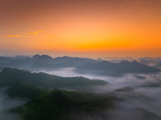 Orange sky and sea of clouds before sunrise. A peaceful, refreshing feeling. View of the hills surrounding Ba Quang, Ha Lang district, Cao Bang province, Vietnam