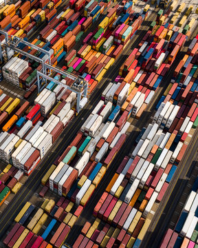 Aerial view of colorful shipping containers and cranes at Corringham port, Stanford Rivers, England.