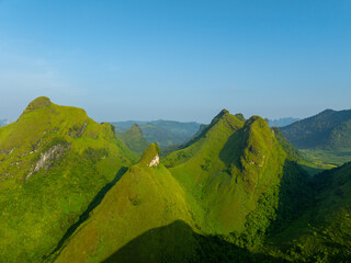 Fototapeta premium Orange sky and sea of clouds before sunrise. A peaceful, refreshing feeling. View of the hills surrounding Ba Quang, Ha Lang district, Cao Bang province, Vietnam