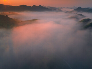 Orange sky and sea of clouds before sunrise. A peaceful, refreshing feeling. View of the hills surrounding Ba Quang, Ha Lang district, Cao Bang province, Vietnam