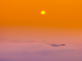 Orange sky and sea of clouds before sunrise. A peaceful, refreshing feeling. View of the hills surrounding Ba Quang, Ha Lang district, Cao Bang province, Vietnam