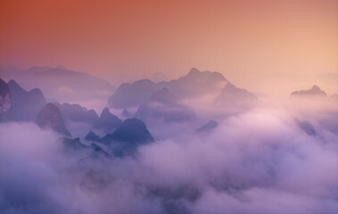 Obraz premium Orange sky and sea of clouds before sunrise. A peaceful, refreshing feeling. View of the hills surrounding Ba Quang, Ha Lang district, Cao Bang province, Vietnam