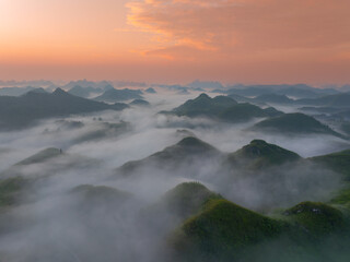 Orange sky and sea of clouds before sunrise. A peaceful, refreshing feeling. View of the hills surrounding Ba Quang, Ha Lang district, Cao Bang province, Vietnam