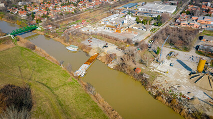 Aerial view on excavator, tow truck and tugboat as they move part of vessel