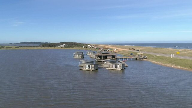 Aerial view of tranquil Laguna Jose Ignacio with serene wooden pier and beautiful landscape, Garzon, Uruguay.