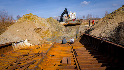 Aerial view on excavator as move part of vessel's bed