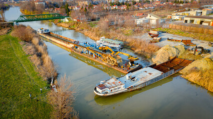 Aerial view on workers as they manually cutting old ship with blowtorch, mixing oxygen and...