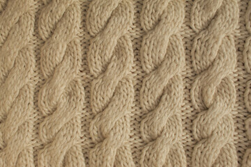 Winter woolen knitting beige sweater clothing. Textile background