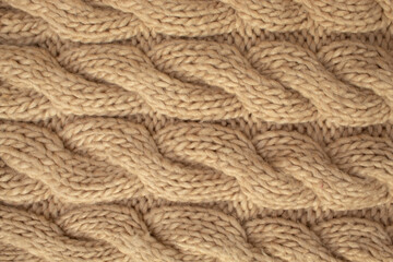 Winter wool hand-knit beige sweater. Clothes textile background