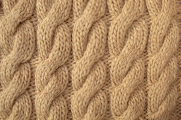 Winter wool hand-knit beige sweater. Clothes textile background
