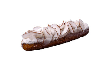 Sweet eclair with custard decorated with coconut slices