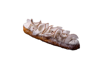 Sweet eclair with custard decorated with coconut slices