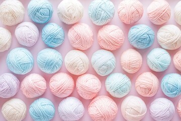 A pastel-colored background featuring balls of yarn, arranged in an organized pattern on the surface. 