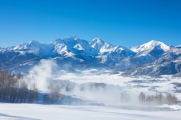 Snow-covered mountains in a clear blue sky showcasing a tranquil winter landscape in a remote valley during midday