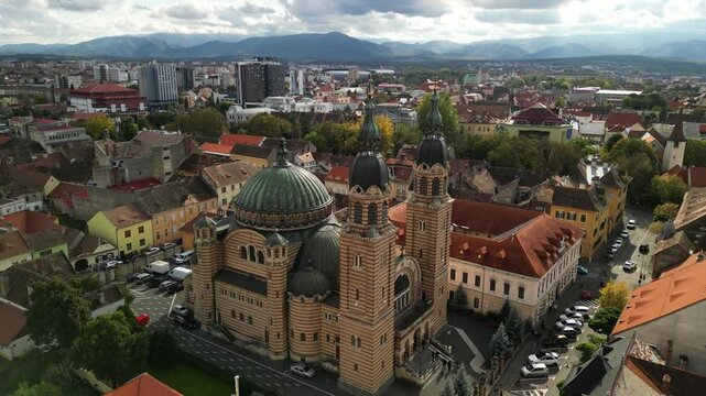 Aerial view of the majestic Orthodox Cathedral in Sibiu, Romania, showcasing its intricate architecture and green dome. Catedrala Ortodoxă "Sf&acirc;nta Treime"