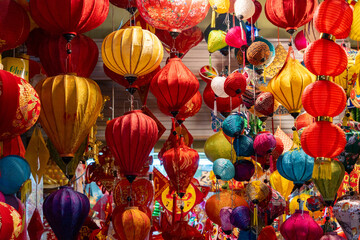 Decorated colorful lanterns hanging on a stand in the streets in Hang Ma street, Ha Noi city, Vietnam during Mid Autumn Festival. © CravenA