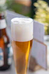 Glass of beer with a head of foam. Table in the restaurant. The Hague, Netherlands.