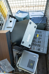 Electronic waste in a pallet cage at the recycling center. Waste management, resources, metal, iron, alloy, plastic, consumer electronics, kitchen appliances.
