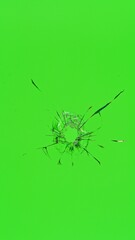 Close-up of gunshot through the glass, shattering against the green background