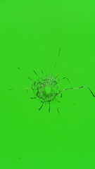 Close-up of gunshot through the glass, shattering against the green background