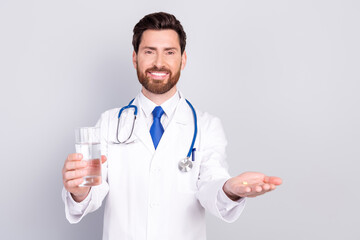 Photo of young doctor intern paramedic wear white robe hold fresh water vitamins isolated on grey color background