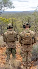 U.S. soldiers in tactical gear communicating during a critical operation in a mountainous war environment