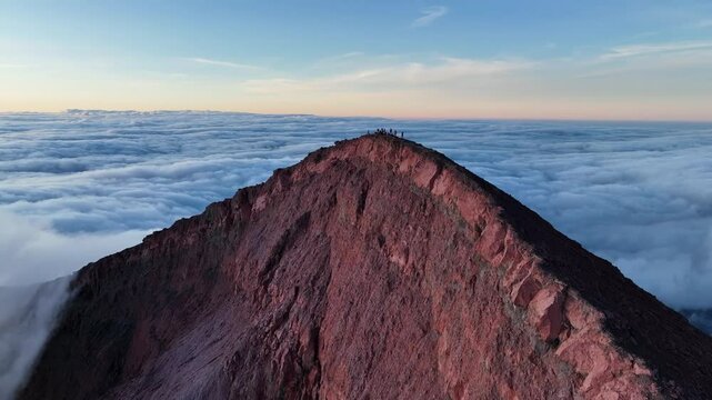 Aerial view of Kerinci Volcano with people standing on the edge of the crater, Sumatra, Indonesia.